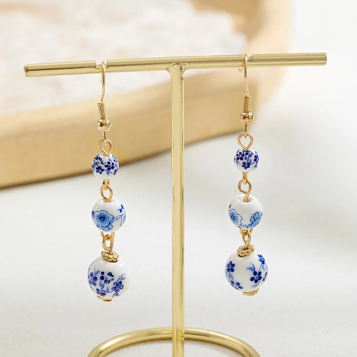 Long retro earrings with blue and white porcelain ceramic beads and geometric alloy construction
