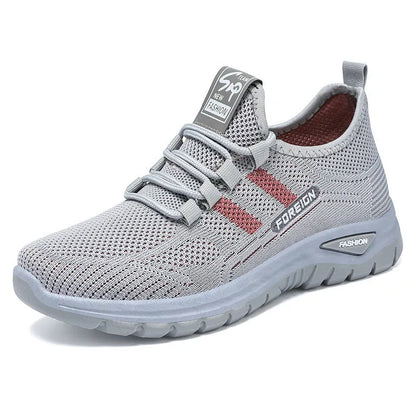Low-top casual shoes with mesh upper and flat PVC sole in black, grey, purple, or red.