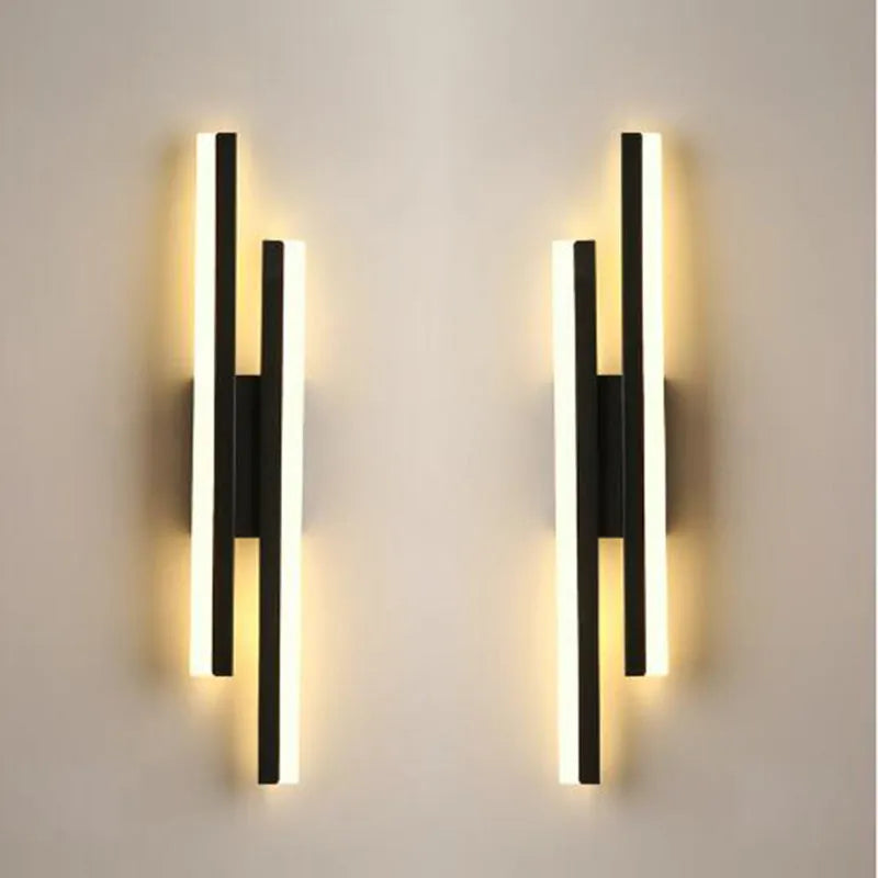 Scandinavian minimalist LED wall light with acrylic shade and adjustable arm in black or gold finish.