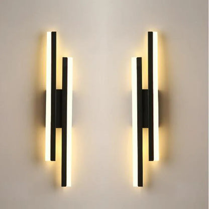 Scandinavian minimalist LED wall light with acrylic shade and adjustable arm in black or gold finish.