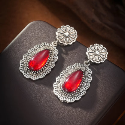 Pair of retro Bohemian carved drop earrings in red alloy for women, shown as a single pair