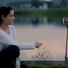 A 3-in-1 wireless Bluetooth selfie stick and tripod with a smartphone mounted on top, allowing for remote-controlled photography and video capture.