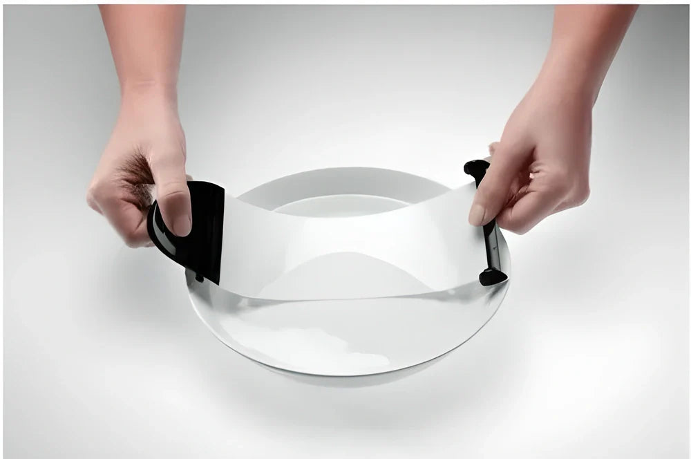 A sleek, compact sushi roller machine with black and transparent components for easy, effortless homemade sushi creation